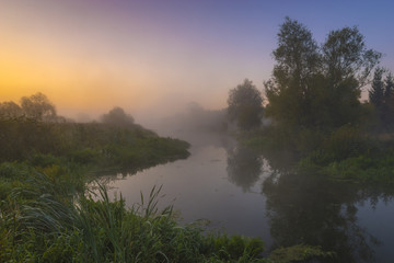 Fototapeta na wymiar eautiful, misty morning on the river in the summer