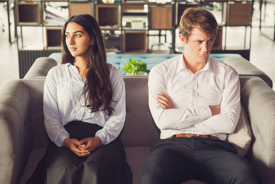 Resentful colleagues looking away from each other