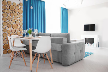 Interior of light modern dining room with served table