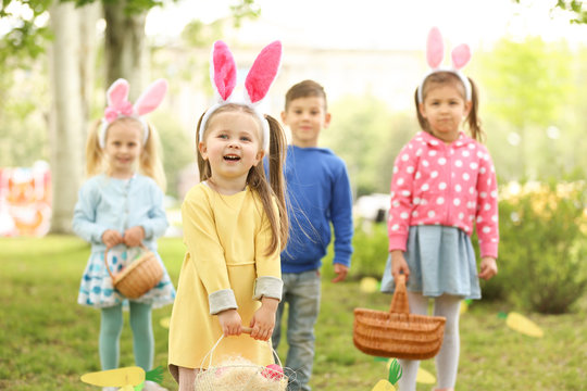 Children Having Fun In Park. Easter Egg Hunt Concept