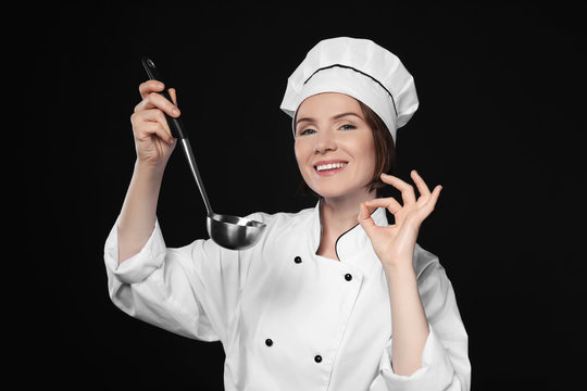 Female Chef With Ladle On Dark Background