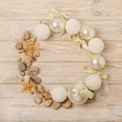 Christmas and New Year. Christmas wreath of Christmas-tree white toys in marine style, shells, stones and starfish.