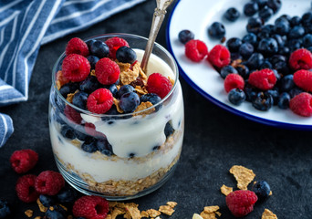 Healthy breakfast with Homemade granola. Muesli, fresh berries and yogurt in glass  jar.