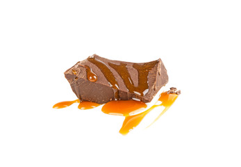 Fototapeta premium a slice of chocolate in caramel isolated in a white background