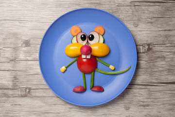 Funny vegetable mouse made on plate and wooden background
