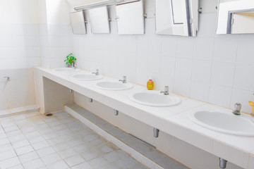 chrome faucet old white sink in interior bathroom public with copy space add text