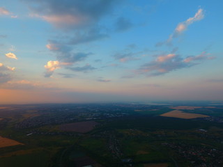 Aerial view of beautiful village, houses, roads. Sky, clouds.