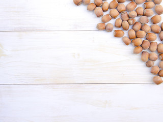 Hazelnut on white wooden background. Top view.
