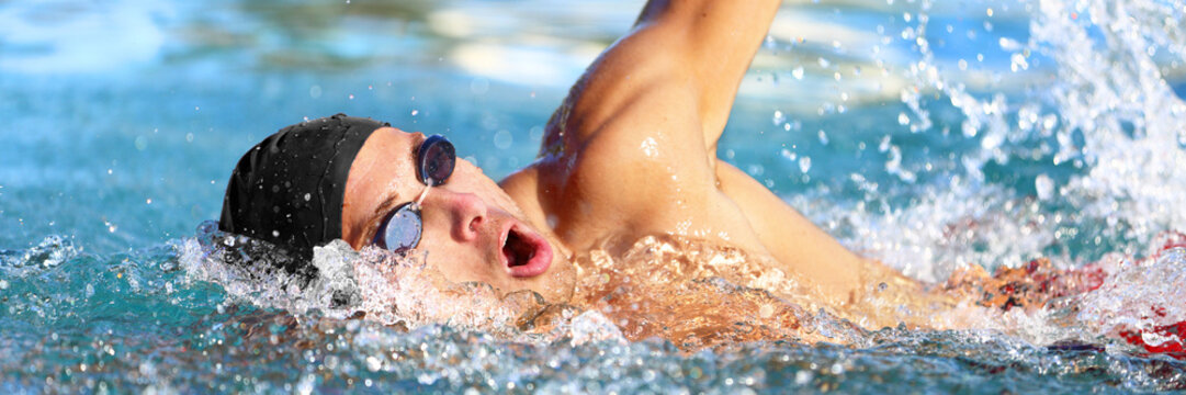 Swimming pool sport crawl swimmer athlete banner. Man doing freestyle stroke technique in water pool lane training for competition. Healthy active lifestyle panoramic header for copy space.