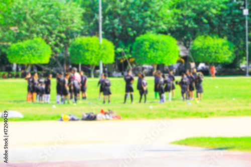 Blurry Of Kids Group Playing Football On Green Soccer Pitch