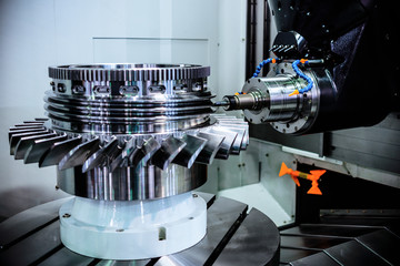 A modern CNC milling machine makes a turbine wheel.