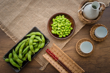Japan pigeon pea or Edamame or Soybeans with SAKE on wooden table
