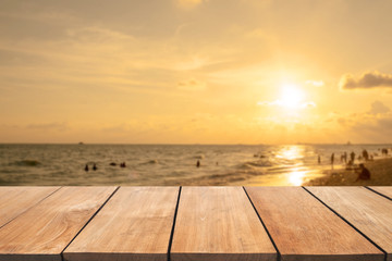Empty wooden table and blurred  sunset beach background