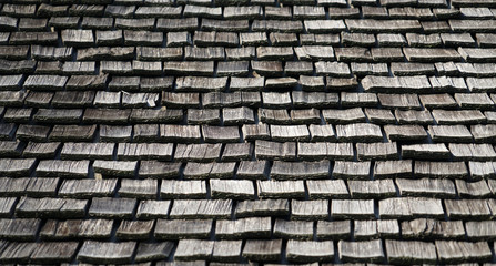 Grunge cedar wood shingle on the roof as background