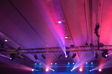 Multiple spotlights, Colorful lighting rig over stage.