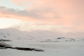 Wind blows snow away from mountain peak.
