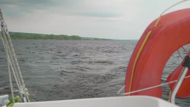 View of shore form yacht board which is on choppy water