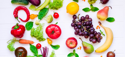 Top view Assortment of bright organic fresh fruits and vegetables on the white wooden table. Healthy eating, diet, detox background. Wide format
