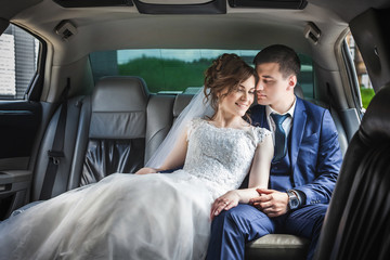 newlywed couple hugging in car