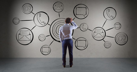 Businessman watching contact and internet sketch on a wall 3D rendering