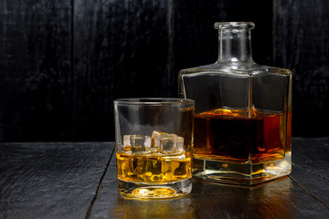 whiskey with a decanter on a wooden background