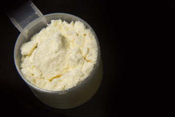 the whey protein powder closeup image black background