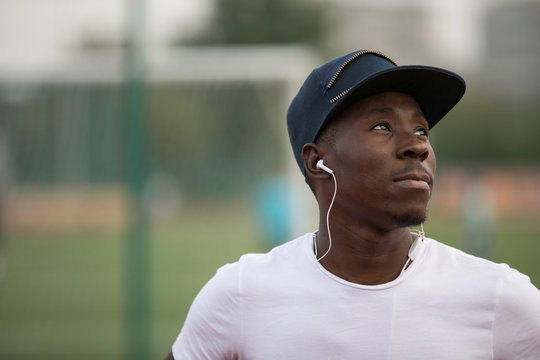 Confident african american male sportsman and trainer against stadium background