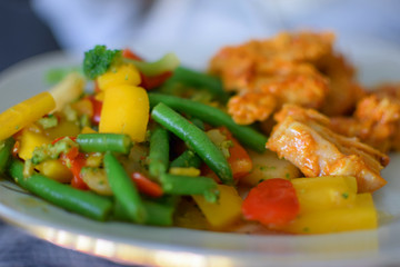 Close up of fried vegetables and chicken. Delicious Asian meal image. Side view with selective focus. 