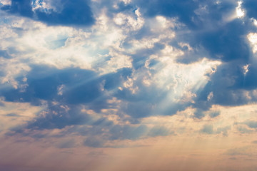 rays of the sun make their way through dramatic clouds