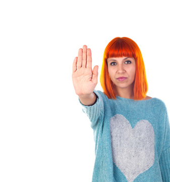 Redhead girl showing the hand palm saying STOP