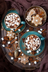 Cups of hot chocolate with marshmallows and  gingerbread cookies on wooden background, christmas concept