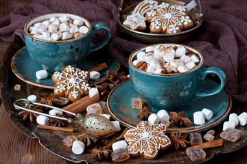 Cup of hot chocolate with marshmallows and gingerbread cookies on a wooden table, christmas concept