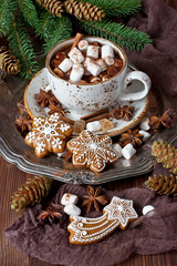 Cup of creamy hot chocolate with melted marshmallows and gingerbread cookies  for christmas holiday