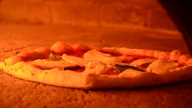 Baking pizza in traditional oven.