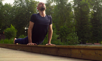 A man doing yoga exercises in the park