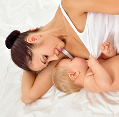 Young mother breastfeeds her baby. Breast-feeding.