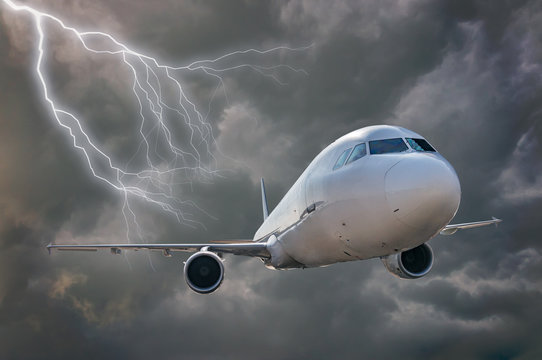 Fototapeta Airplane is flying in storm. Dark clouds and lightning in background.