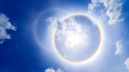 Obraz na płótnie Canvas sun corona rainbow clouds and blue sky background , Circumscribed halo
