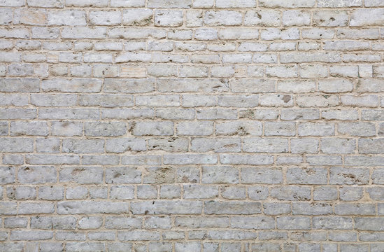 Wall of white travertine adarce stone bricks