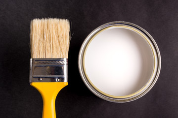 White Paint Can with Brush Top View On Black Background.