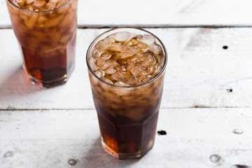 Cola drink glass on white table