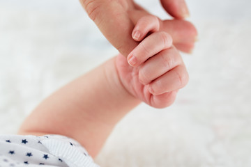 Child's hand holding his dad, close up