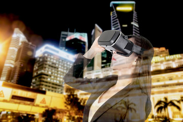 Young woman enjoy with virtual reality glasses on city background