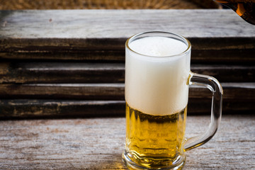 mug of beer on wood background