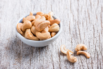 Roasted cashew nuts on rustic wood