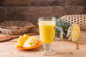 Pineapple smoothie  on wood background