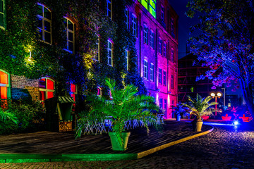 Illuminated terrace of an old building in blue and pink in old district
