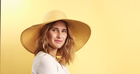 Smiling blonde woman wearing hat