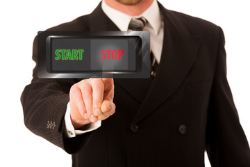 Happy young businessman in suit and tie pressing STOP virtual button