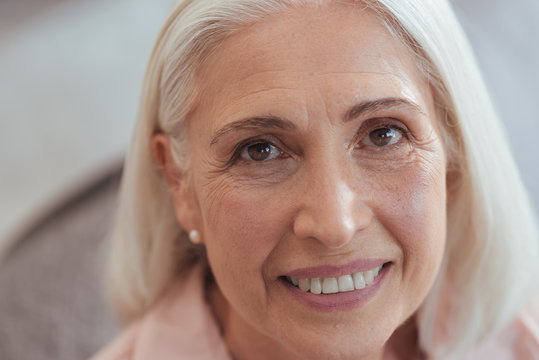 Close up of an open minded aged smiling woman
